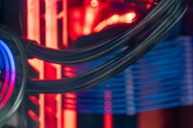 A detailed view of a custom water-cooling loop inside a gaming PC, showcasing the water block, tubing, radiator, and reservoir.