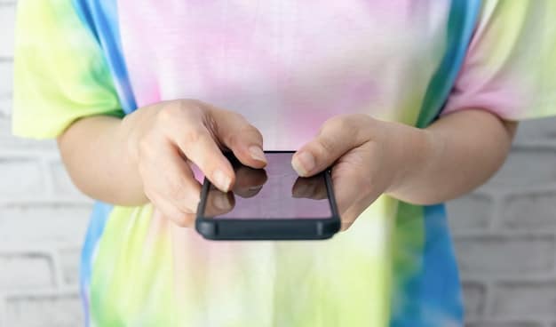 A person's hands holding a mobile phone, with a vibrant and engaging game displayed on the screen. The image focuses on the interaction between the person and the game, highlighting the immersive nature of mobile gaming.