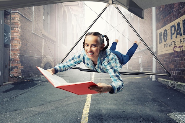 A split-screen showing a student-athlete intensely playing a game on one side and diligently studying textbooks on the other, symbolizing the balance required for collegiate esports success.