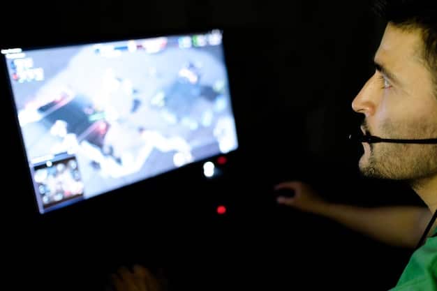A close-up shot inside an esports training facility, focusing on a coach analyzing gameplay footage with a player. The coach is pointing at a screen displaying game analytics, while the player listens attentively. The scene highlights the data-driven approach to esports training.